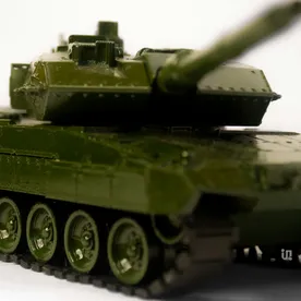 A hand-painted olive scale-model tank, up close.